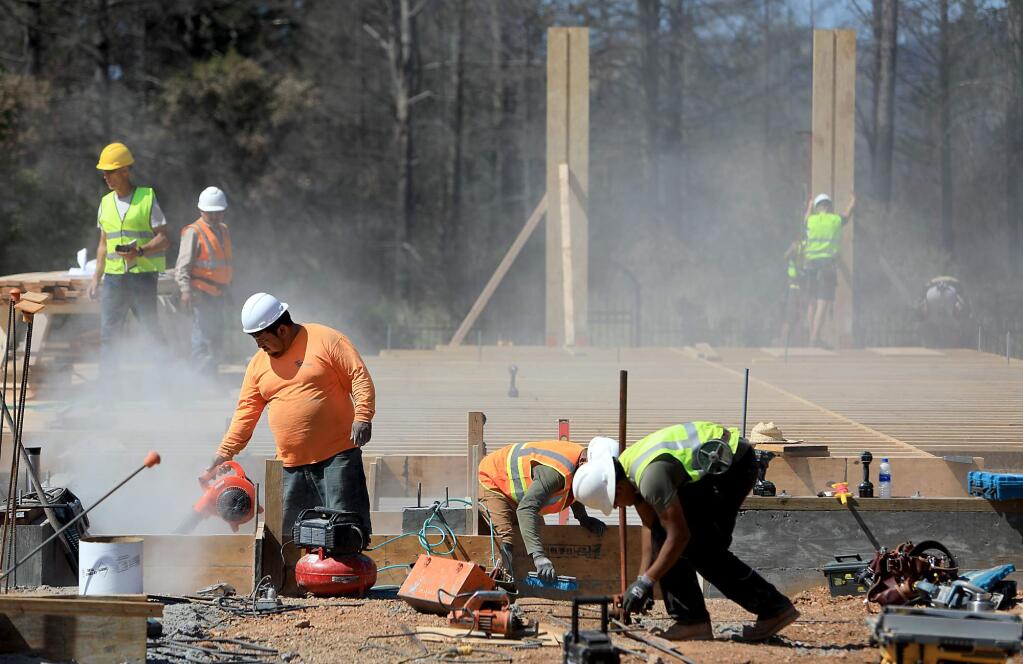 Construction workers build forms for a house in the Fir Ridge neighborhood of Fountaingrove, Monday, May 21, 2018, in Santa Rosa. The home was razed during the Tubbs fire. (Kent Porter / The Press Democrat) 2018