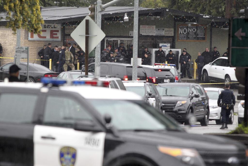 Oakland police work on the scene at an active shooter incident Friday, Feb. 17, 2017, in Oakland, Calif. Officials say a gunman who fired numerous shots Friday morning in east Oakland near the zoo has been disarmed and is in police custody. Officers were called to a neighborhood near the Oakland Zoo for a report of a man armed with a rifle and shooting in the neighborhood, a police spokeswoman said. (Anda Chu/Bay Area News Group via AP)