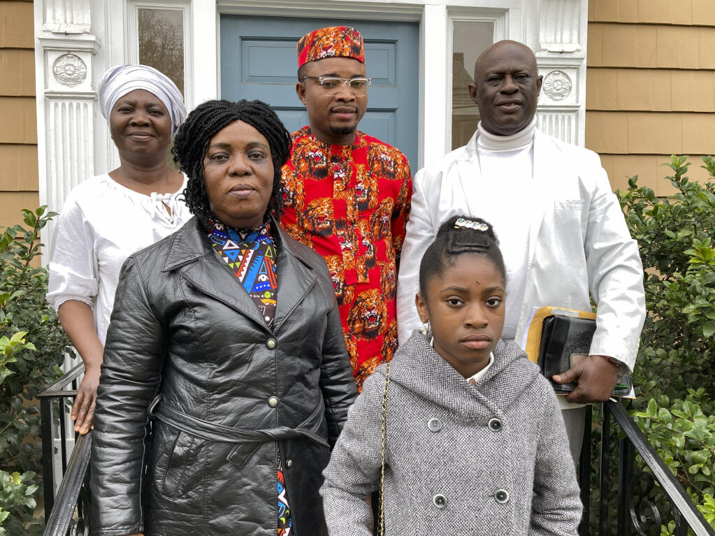 From left, Mary Dwumfour, Afua Sefa, Peter Ezechukwu, Nicole Teliano and Prince Dwumfour pose for a portrait in front of a law office in Sayreville, N.J., April 5, 2023. Their family member, Eunice Dwumfour, a Sayreville council member, was fatally shot Feb. 1 as she arrived home in Sayreville. (AP Photo/Michael Rubinkam)