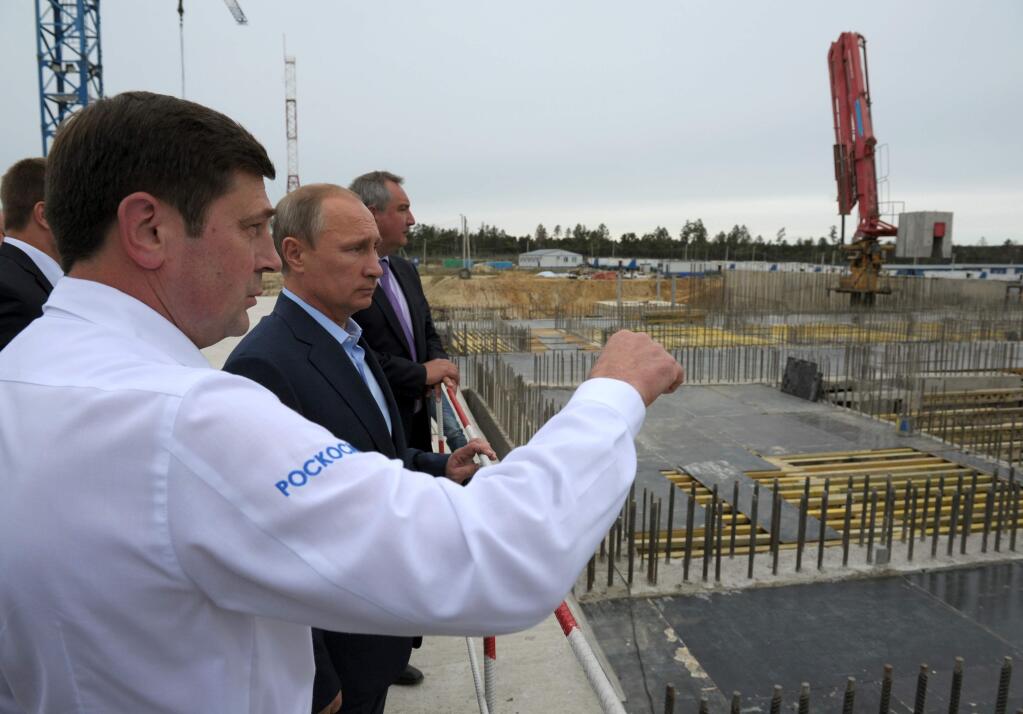 FILE - In this Sept. 2, 2014 file photo, Russian President Vladimir Putin, second left, and Vice Premier Dmitry Rogozin, third left, listen to then Russian Space Agency chief Oleg Ostapenko, left, while visiting a construction site of the Vostochny Cosmodrome near Uglegorsk, eastern Siberia, in the Amur region, Russia. Back-to-back rocket launch failures have dealt Russia one of the heaviest blows to its space industry since the Soviet collapse _ with national pride and billions of dollars at stake. The setbacks threaten to erode Russias leading position in the multibillion global launch market, in which it commands an estimated 40 percent share, and dent Putins efforts to boost the countrys global prestige. The competition for lucrative commercial satellite contracts is intensifying, with American, European, Chinese and Indian companies all eager to expand their share. Rogozin warned this week that Russia could soon lose its chunk if the problems arent fixed quickly. (Alexei Druzhinin/RIA-Novosti, Kremlin Pool Photo via AP, File )