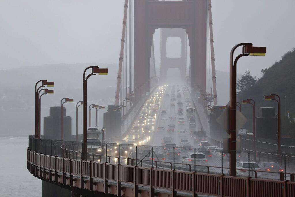 FILE - In this Jan. 5, 2016, file photo, traffic crosses the Golden Gate Bridge in the rain in this view from Sausalito, Calif. (AP Photo/Eric Risberg)