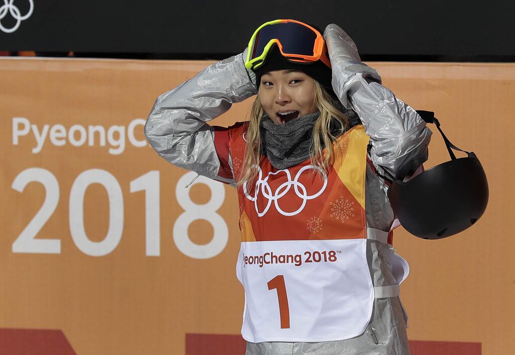 Chloe Kim, of the United States, reacts to her score during the women's halfpipe finals at Phoenix Snow Park at the 2018 Winter Olympics in Pyeongchang, South Korea, Tuesday, Feb. 13, 2018. (AP Photo/Gregory Bull)