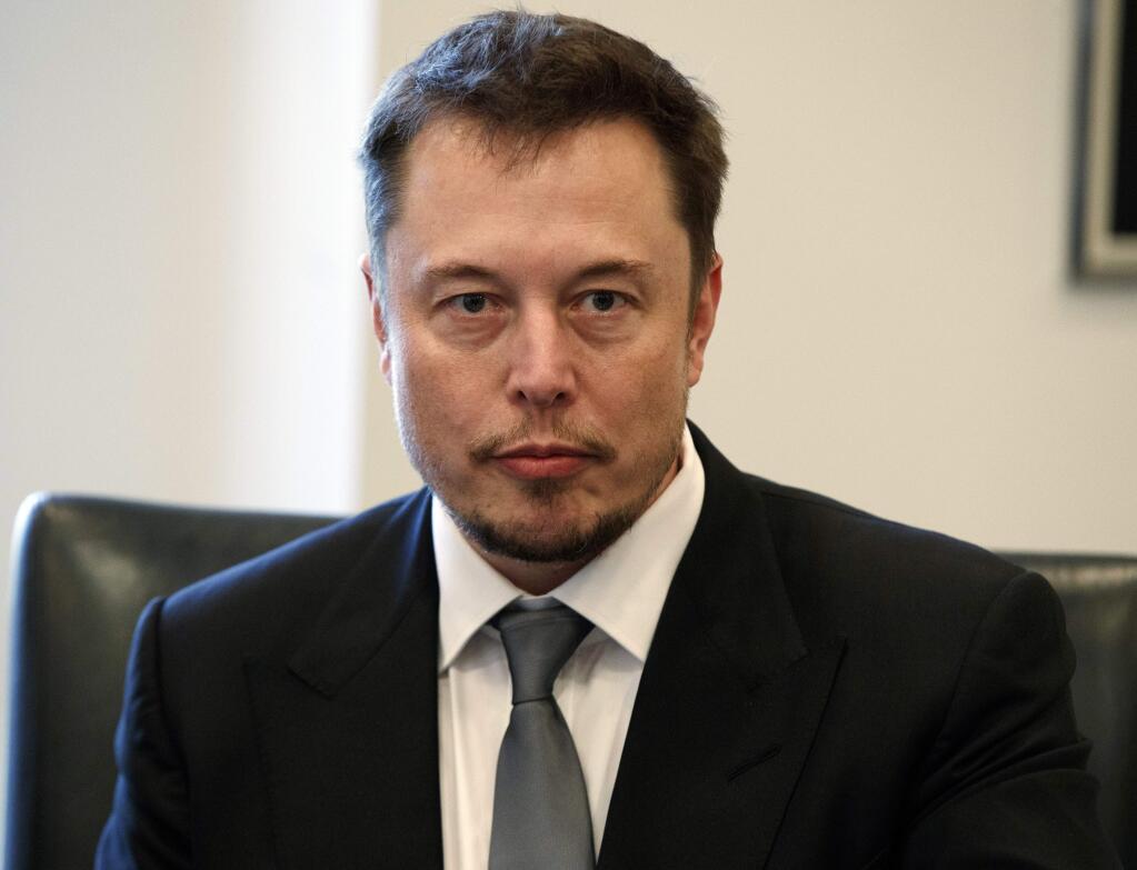 FILE - In this Dec. 14, 2016, file photo, Tesla CEO Elon Musk listens as President-elect Donald Trump speaks during a meeting with technology industry leaders at Trump Tower in New York. In a Tweet, Musk says he has 'verbal government approval' to build a tunnel for high-speed transportation from New York to Washington. The billionaire entrepreneur didn't say who gave him the approval. But the White House confirmed it had 'positive discussions' about the tunnel with Musk and executives from his underground drilling enterprise, The Boring Co. (AP Photo/Evan Vucci, File)
