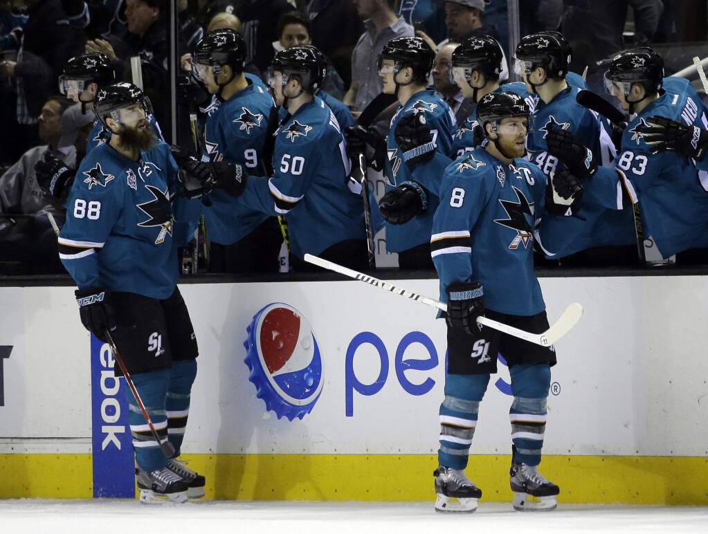 San Jose Sharks' Brent Burns (88) celebrates after scoring with teammates on the bench during the second period of an NHL hockey game against the Colorado Avalanche Tuesday, Jan. 26, 2016, in San Jose, Calif. (AP Photo/Marcio Jose Sanchez)