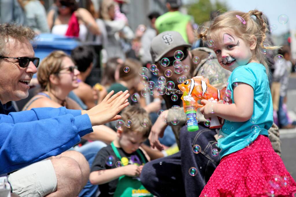 Three-year-old Lily Amaya of Petaluma sprays bubbles during the Butter & Egg Days Parade. (Allison Jarrell)