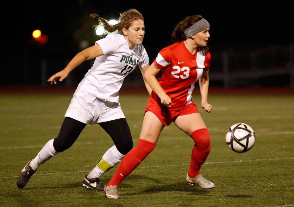 Montgomery's Eden Brooker (23) looks to pass while Maria Carrillo's Sydney Rickert (17) defends during the first half of the NCS Division 1 championship girls soccer match on Saturday, Nov. 14, 2015. (Alvin Jornada / The Press Democrat)