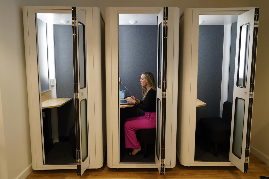 Kelly Soderlund works in a quiet booth on a hybrid workday at the TripActions office in San Francisco, Friday, Aug. 27, 2021. A new survey from Sonoma-based employment agency Nelson Connects found return-to-work decisions are a pressing issue among California employers. (AP Photo/Eric Risberg)