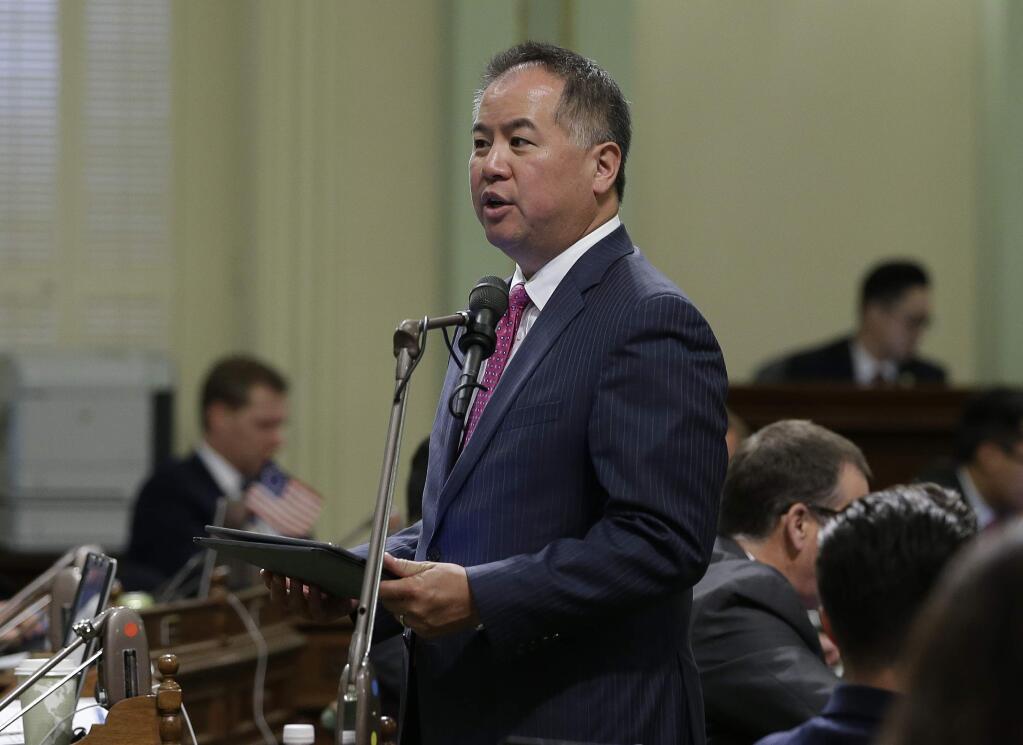FILE - In this June 25, 2018, file photo, Assemblyman Phil Ting, D-San Francisco, chairman of the Assembly budget committee, speaks on the floor of the State Capitol in Sacramento, Calif. A Northern California lawmaker and district attorney are seeking to automatically clear some 8 million criminal convictions eligible for sealing but remain public records. San Francisco District Attorney George Gascon and state Democratic Assemblyman Phil Ting of San Francisco a proposed a bill Thursday, March 7, 2019, to automatically take advantage of an often overlooked California law allowing convicted drunken drivers, burglars and other low-level offenders to seal their records. (AP Photo/Rich Pedroncelli, File)