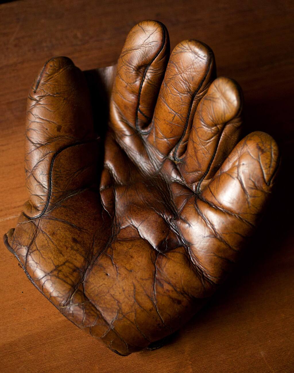 A glove circa 1900. Fran Fleet, 'The Glove Lady,' has been repairing baseball gloves out of her tiny Cotati shop for over 40 years. (JOHN BURGESS / The Press Democrat)