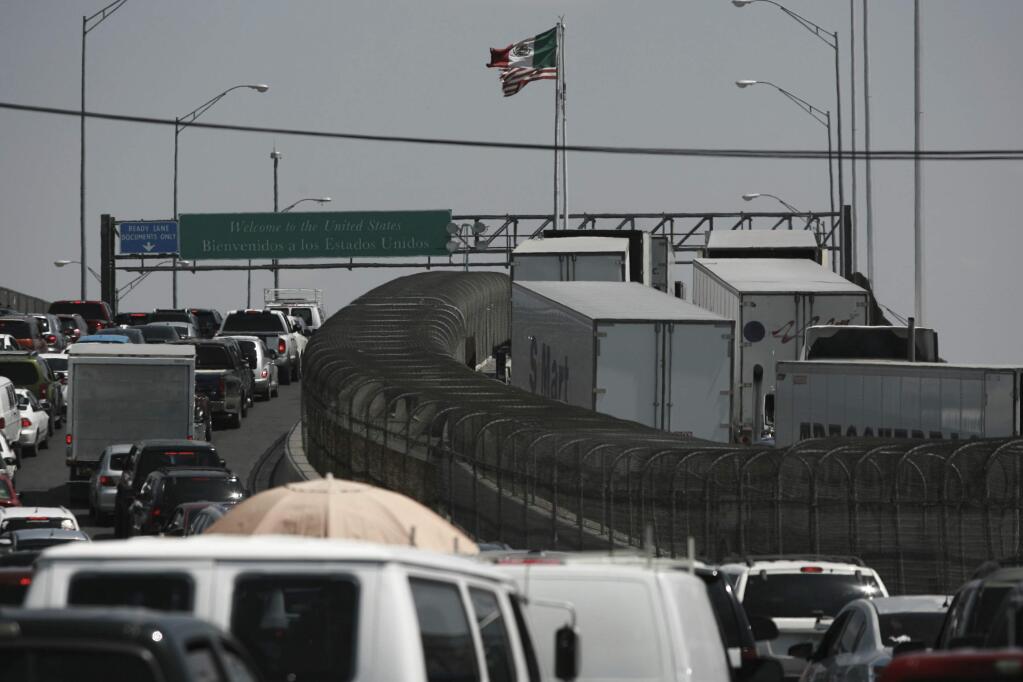 Trucks line up at the Cordova - Las Americas international bridge to cross with their cargo from Mexico into the United States in Ciudad Juarez, Mexico, Friday, May 31, 2019. (AP Photo/Christian Torrez)