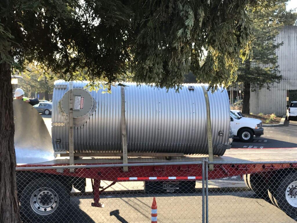 Crews install a 2,200-gallon steel rainwater harvesting tank at Santa Rosa City Hall's water efficiency demonstration garden on Wednesday, March 1, 2017. (COURTESY OF DEB LANE/ CITY OF SANTA ROSA)