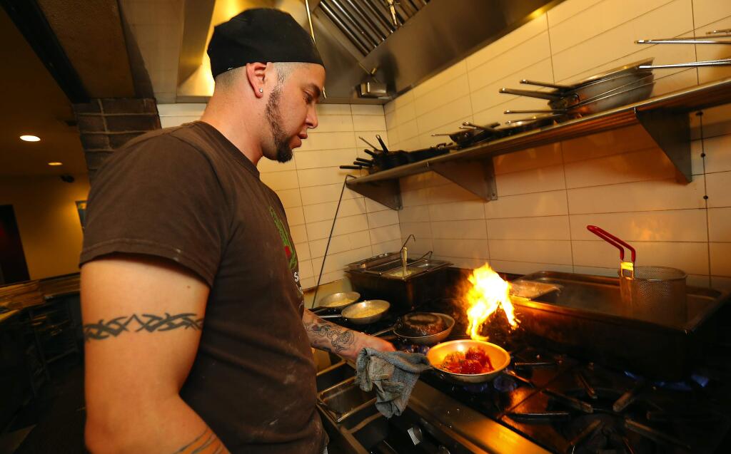 Line cook Carlos Torres cooks meatballs at Rosso Pizzeria and Wine Bar in Santa Rosa. (JOHN BURGESS / The Press Democrat)