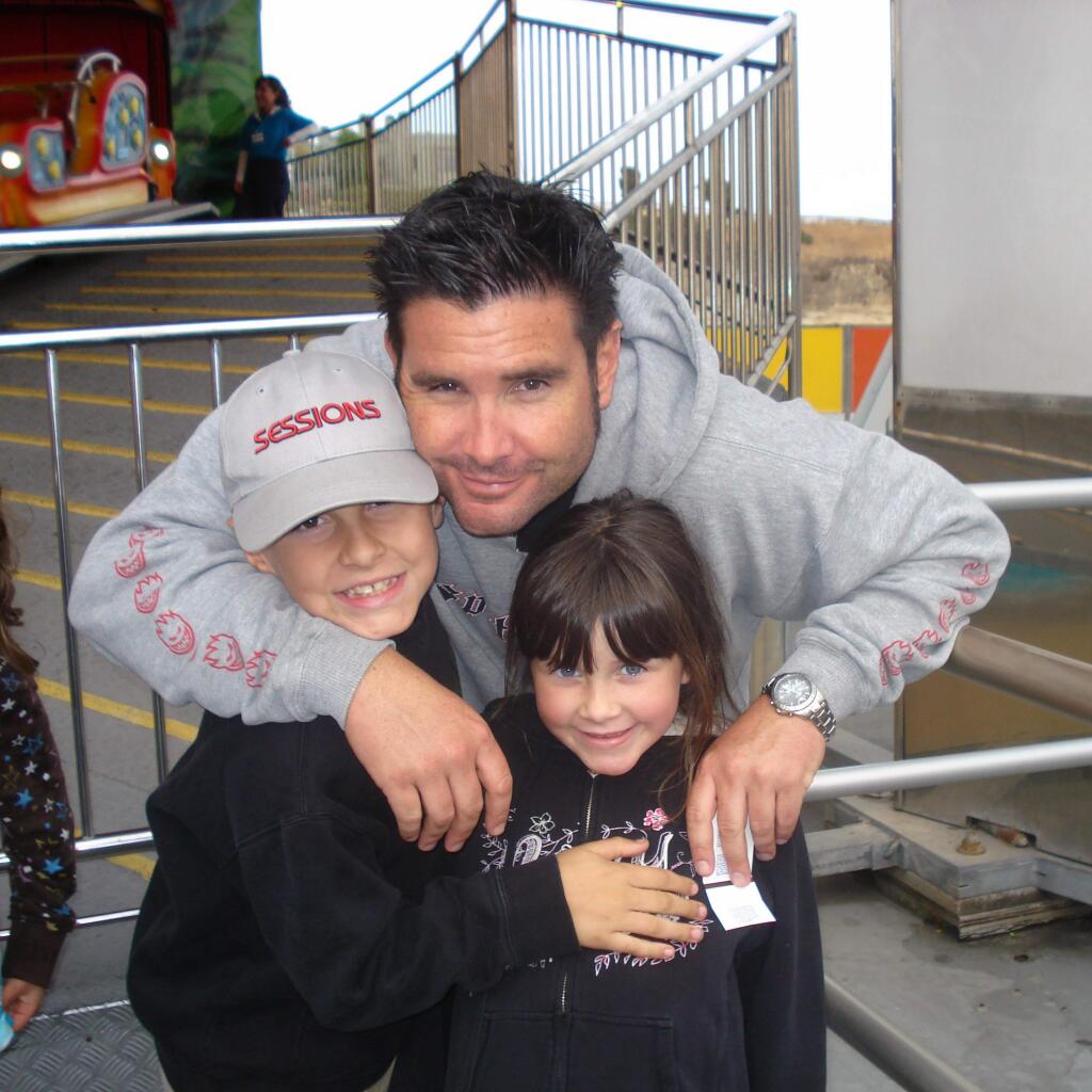 FILE - This undated file photo provided Tuesday April 5, 2011 by John Stow shows Bryan Stow holding his 12-year-old son and 8-year-old daughter. Stow who suffered a traumatic brain injury after being beaten by two Dodger fans put up his hands and fingers, fist bumped his mom and talked about his goals in a new interview three years after the attack outside Dodger Stadium. Stow, wearing a Giants tank top, spoke to ESPN on Tuesday, Oct. 21, 2014 from his parents home in the Northern California city of Capitola, where he watched Game 1 of the World Series between the Giants and Kansas City Royals. (AP Photo/John Stow, File)
