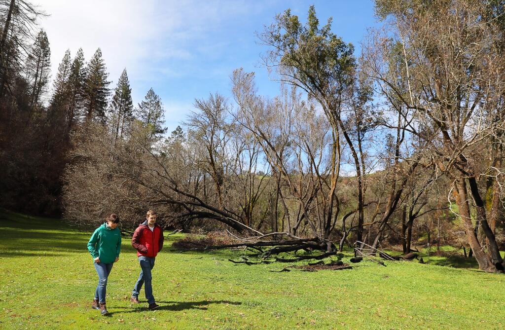 Sonoma County Agricultural Preservation and Open Space District community relations specialist Amy Ricard and associate planner Fraser Ross tour part of the district's land along Mark West Creek on Wednesday, March 14, 2018. The land has since been transferred to the county’s Regional Parks department. (Christopher Chung/ The Press Democrat)
