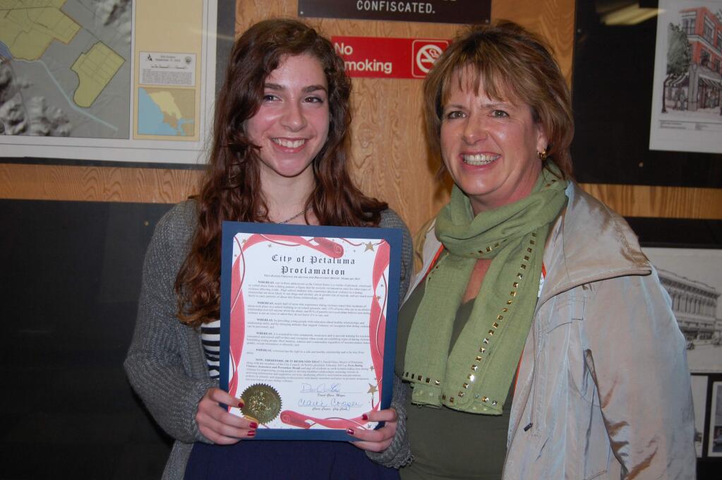 E.A. BARRERA/ARGIS-COURIER STAFFCasa Grande senior Sara Soss, with advisor Trisha Almond, shows city proclamation honoring her for her work in promoting Teen Dating Awareness Month.