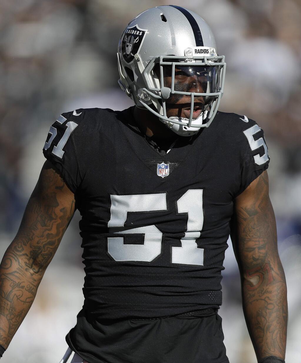 In this Dec. 3, 2017, file photo, Oakland Raiders outside linebacker Bruce Irvin waits for a play by the New York Giants during a game in Oakland. (AP Photo/Marcio Jose Sanchez, File)