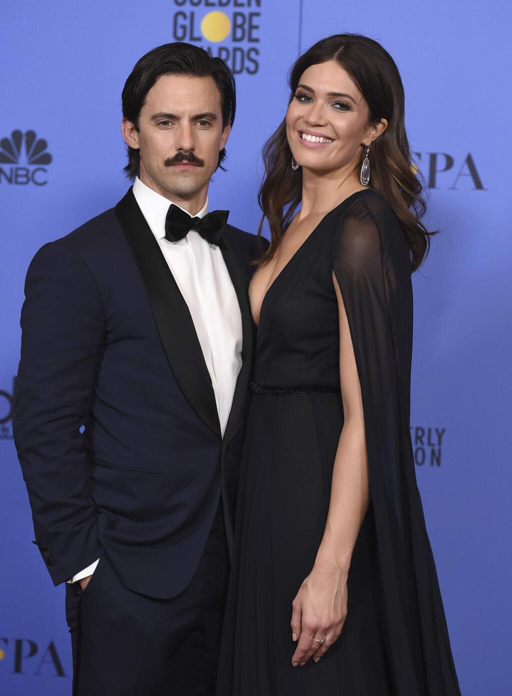 FILE - This Jan. 8, 2017 file photo shows Milo Ventimiglia, left, and Mandy Moore in the press room at the 74th annual Golden Globe Awards in Beverly Hills, Calif. The season finale for the popular time-twisting family drama will air Tuesday at 9 p.m. EST on NBC. (Photo by Jordan Strauss/Invision/AP, File)