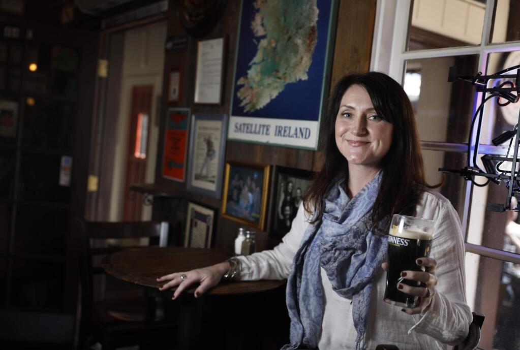 Darby Tarantino, the operations manager at Meadowcroft Wines, drinks a pint of Guinness at Murphy's Irish Pub on Thursday, March 2, 2017 in Sonoma, California . (BETH SCHLANKER/The Press Democrat)