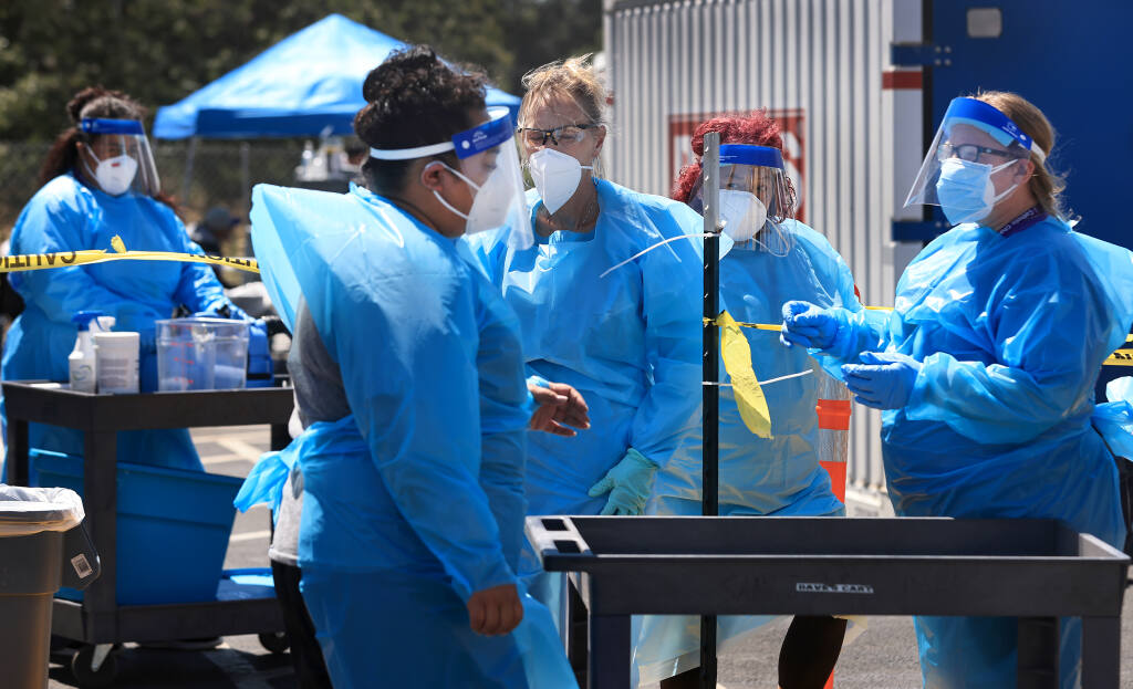 Catholic Charities staff workers prepare to clean facilities at Santa Rosa’s Sam Jones Hall homeless shelter, where at least 59 cases of COVID-19 have been confirmed as of Wednesday, July 14, 2021.   (Kent Porter / The Press Democrat)