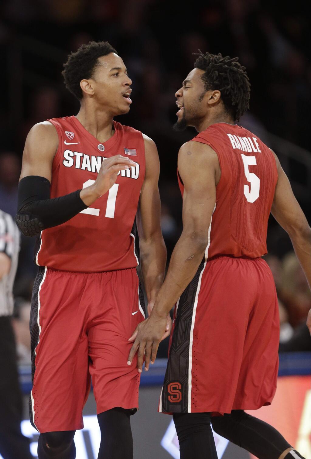 Stanford's Anthony Brown (21) and Chasson Randle (5) celebrates after Brown made a 3-point basket during the first half of a semifinal against Old Dominion at the NIT college basketball tournament Tuesday, March 31, 2015, in New York. (AP Photo/Frank Franklin II)