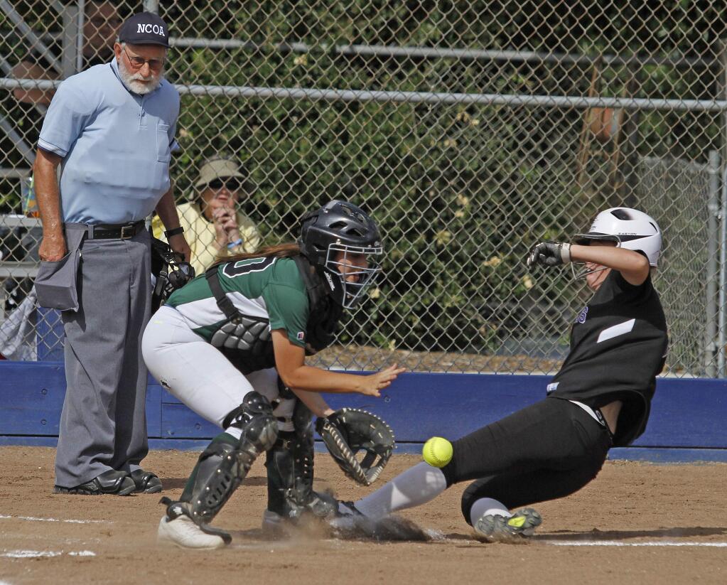 Sonoma catcher Beverly Harris tries to put a tag on a sliding Petaluma runner in the Thursday, May 19, SCL tournament championship game.Photos by Bill Hoban/Index-Tribune