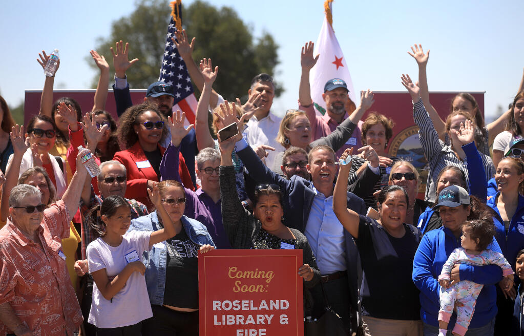 Senate majority leader Mike McGuire, in sport coat, middle right,  participates in a group photo after a announcing $10 million in funding for the Roseland Library and Santa Rosa Fire's station 8, to be located on Hearn Ave. in Santa Rosa, Tuesday, July 19, 2022 in Santa Rosa.  (Kent Porter / The Press Democrat) 2022
