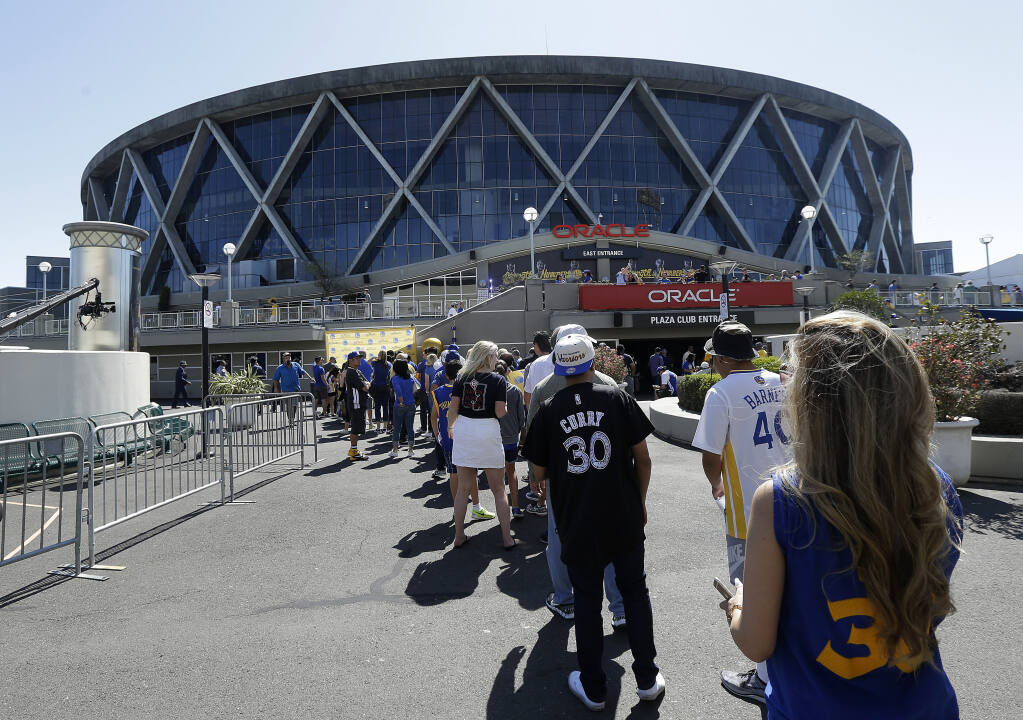 Fans line up outside Oracle Arena before Game 2 of the 2016 NBA Finals between the Warriors and the Cleveland Cavaliers in Oakland. (Jeff Chiu / ASSOCIATED PRESS)