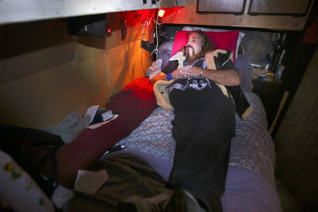 Pershing John 'Pineapple' Diacamos settles in for the night in his van at the Sonoma County Fairgrounds in February. (PD FILE, 2014)