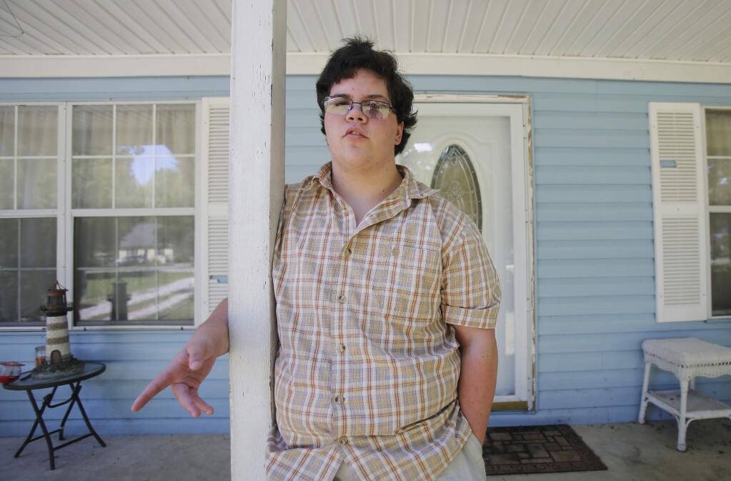 FILE - In this Aug. 22, 2016 file photo, transgender high school student Gavin Grimm poses in Gloucester, Va. The Supreme Court is returning a transgender teen's case to a lower court without reaching a decision. The justices said Monday, March 6, 2017, they have opted not to decide whether federal anti-discrimination law gives high school senior Gavin Grimm the right to use the boys' bathroom in his Virginia school. (AP Photo/Steve Helber, File)