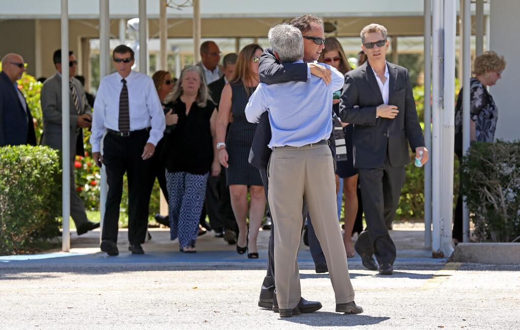 Mourners exit the Parker Playhouse following a memorial service for John Stevens and his wife Michelle Mishcon, Friday, Aug. 19, 2016, in Fort Lauderdale, Fla. A Florida sheriff's office said Friday, that Austin Harrouff, 19, will be charged with two counts of first-degree murder in the couples death, raising the possibility of the death penalty. (Mike Stocker/South Florida Sun-Sentinel via AP)