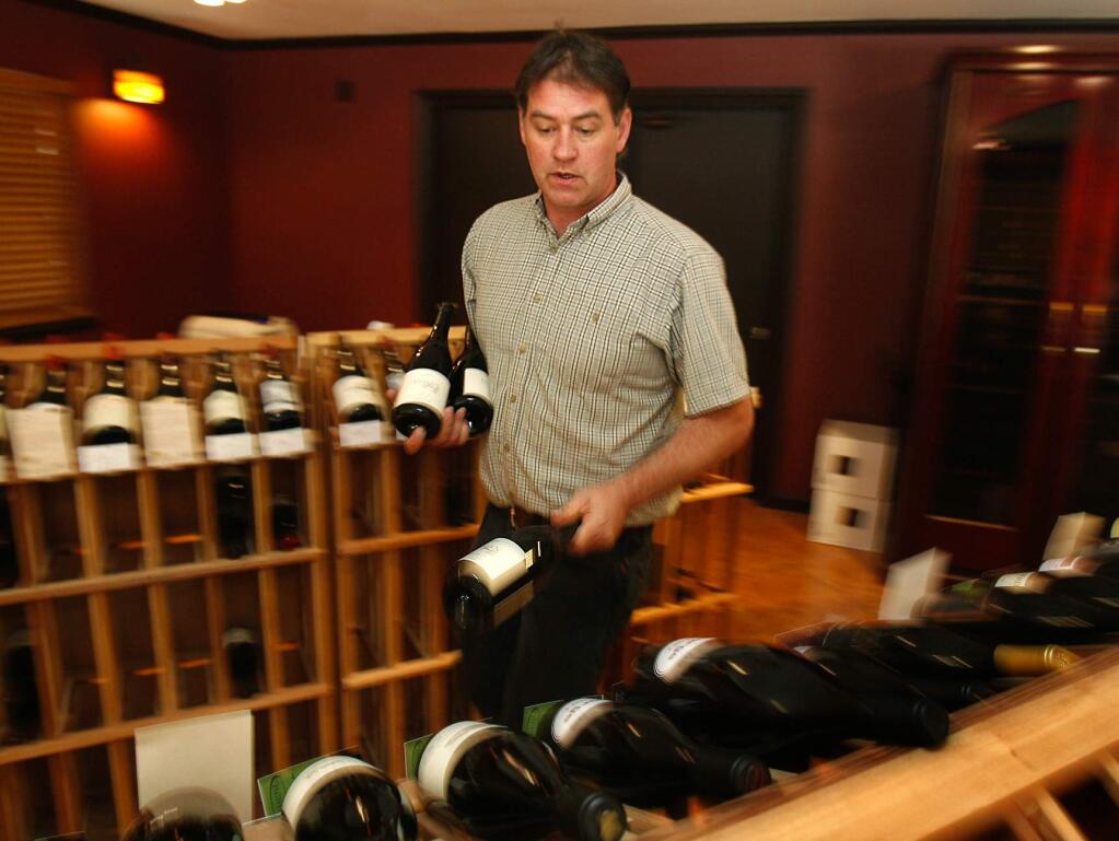 John Haggard, the owner and wine buyer for Sophie's Cellars in Monte Rio stocks wines delivered this week in anticipation of the Bohemian Grove gathering.