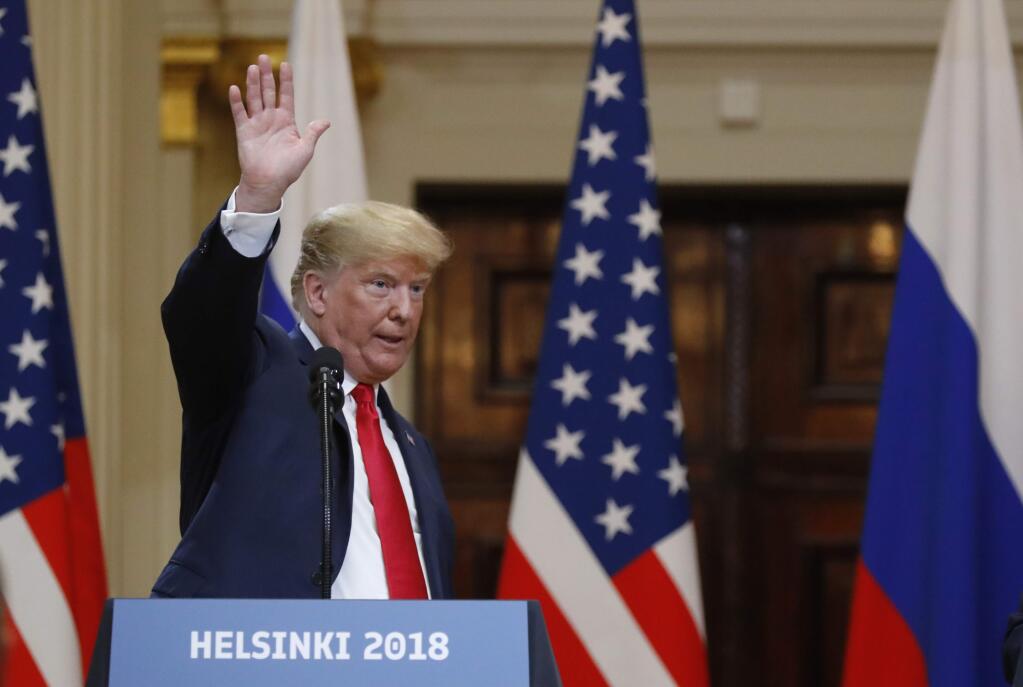 U.S. President Donald Trump waves at the end of a press conference after the meeting of U.S. President Donald Trump and Russian President Vladimir Putin at the Presidential Palace in Helsinki, Finland, Monday, July 16, 2018. (AP Photo/Alexander Zemlianichenko)