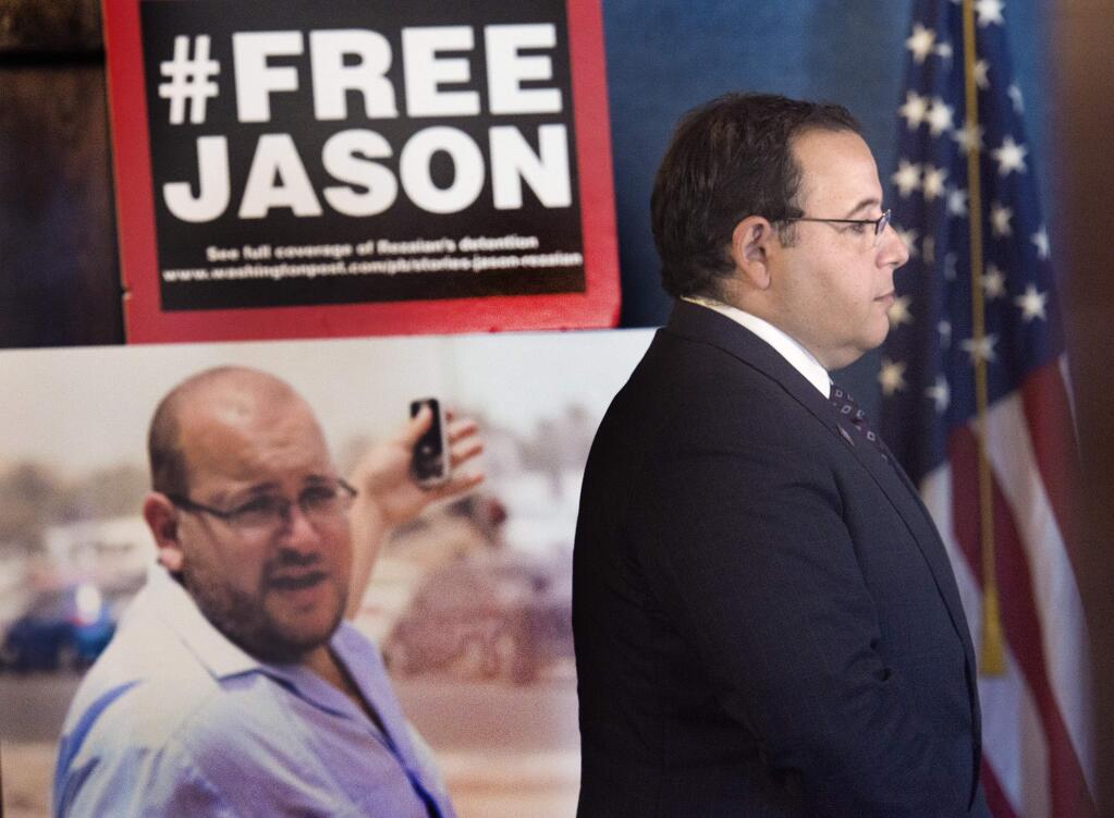 Ali Rezaian, brother of imprisoned Washington Post report Jason Rezaian (in poster), gives reporters an update on his brother's case at the National Press Club in Washington in July.