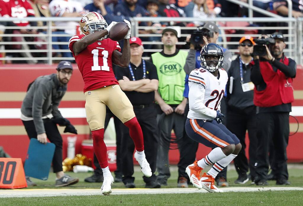 San Francisco 49ers wide receiver Marquise Goodwin catches a pass in front of Chicago Bears cornerback Prince Amukamara, right, during the first half of in Santa Clara, Sunday, Dec. 23, 2018. (AP Photo/Tony Avelar)