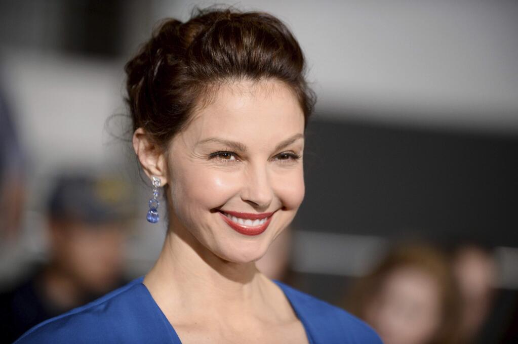FILE - In this March 18, 2014, file photo, Ashley Judd arrives at the world premiere of 'Divergent' at the Westwood Regency Village Theater in Los Angeles. Harvey Weinstein has been fired from The Weinstein Co., effective immediately, following new information revealed regarding his conduct, the company's board of directors announced Sunday, Oct. 8, 2017. The New York Times article chronicled allegations against Weinstein from film star Ashley Judd and former employees at both The Weinstein Co. and Weinstein's former company, Miramax. (Photo by Jordan Strauss/Invision/AP, File)