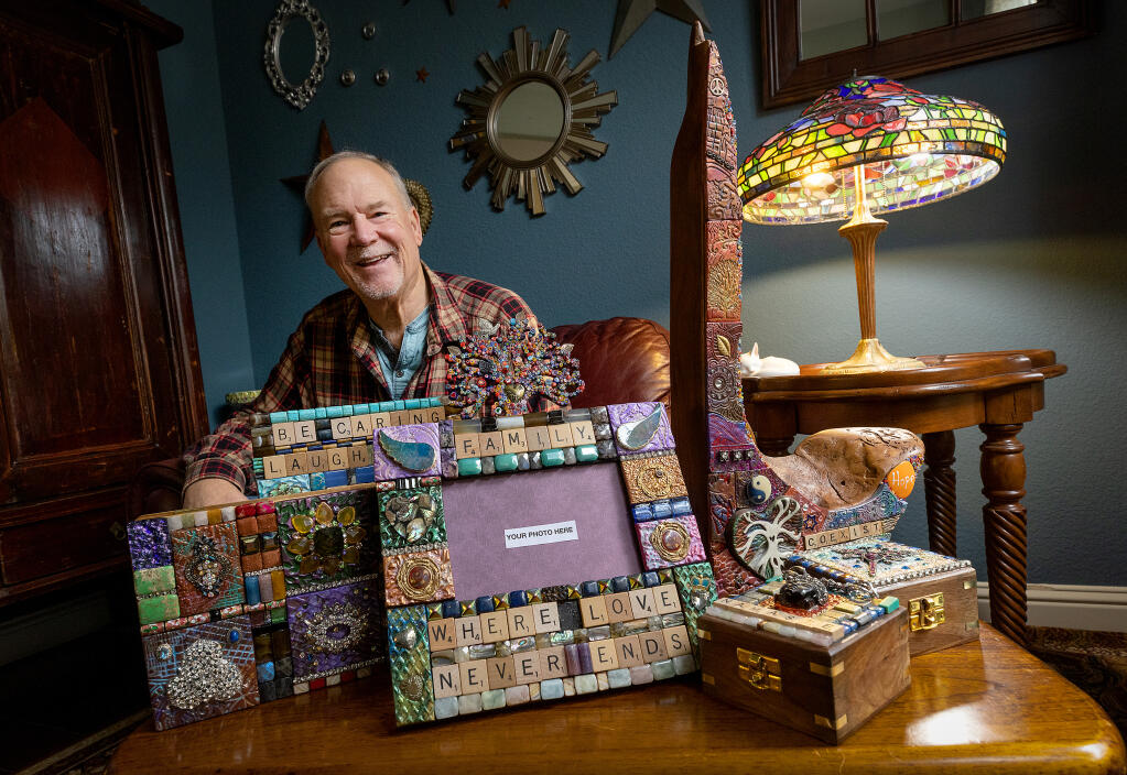 After 31 years with the Dept. of Corrections, Jerry Stocker has spent his retirement fulfilling his creative side making mixed-media mosaic tiles he applies to wood frames, boxes and mirrors in his Cloverdale home Friday, January 13, 2023.  (John Burgess/The Press Democrat)