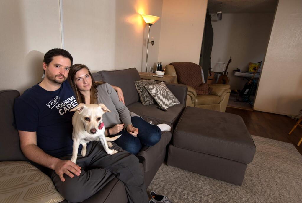 A.J. Ward, and his wife, Christina, sit inside their apartment with their dog, Lucy, in Sebastopol on Saturday, Feb. 8, 2020. (Darryl Bush / For The Press Democrat)