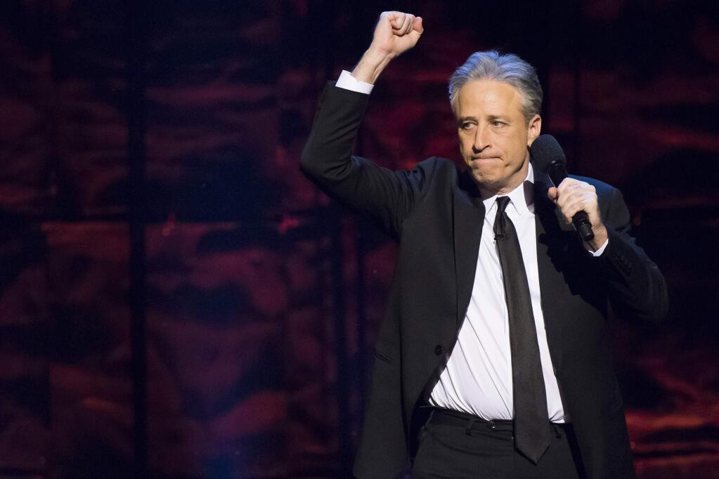 FILE - In this Tuesday, Nov. 10, 2015, file photo, comedian Jon Stewart performs at the 9th Annual Stand Up For Heroes event, presented by the New York Comedy Festival and The Bob Woodruff Foundation, at the Theater at Madison Square Garden in New York. Stewart has returned to The Daily Show where he made a push to renew a law that provides health benefits for first responders who became ill after the Sept. 11 terror attacks. Stewart was a guest on the Daily Show with Trevor Noah on Monday, Dec. 8, 2015. (Photo by Greg Allen/Invision/AP, File)
