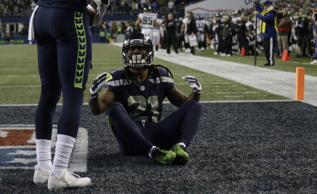 Seattle Seahawks running back J.D. McKissic takes a meditation pose to celebrate his touchdown against the Philadelphia Eagles in the second half of an NFL football game, Sunday, Dec. 3, 2017, in Seattle. (AP Photo/John Froschauer)