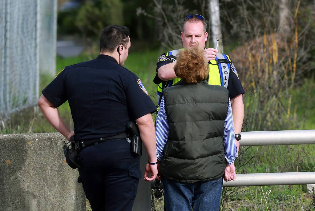 Santa Rosa police officers give a sobriety test to a 77-year-old woman who was arrested for suspected driving under the influence after she hit two pedestrians on Oakmont Drive on Wednesday, Jan. 20, 2016. (JOHN BURGESS / The Press Democrat)