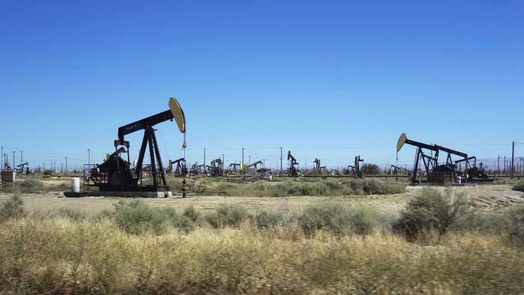 This June 12, 2017 photo shows pumpjacks operating in the western edge of California's Central Valley northwest of Bakersfield. The federal government wants to reopen over 1.7 million acres (690,000 hectacres) in California to oil and gas drilling that includes fracking on land that has been off-limits since environmentalists sued in 2013. The Bureau of Land Management issued final plans Thursday, May 9, 2019 for oil and gas leases on 800,000 acres (324,000 hectacres) of federal land mainly between the Central Coast and Central Valley. (AP Photo/Brian Melley)