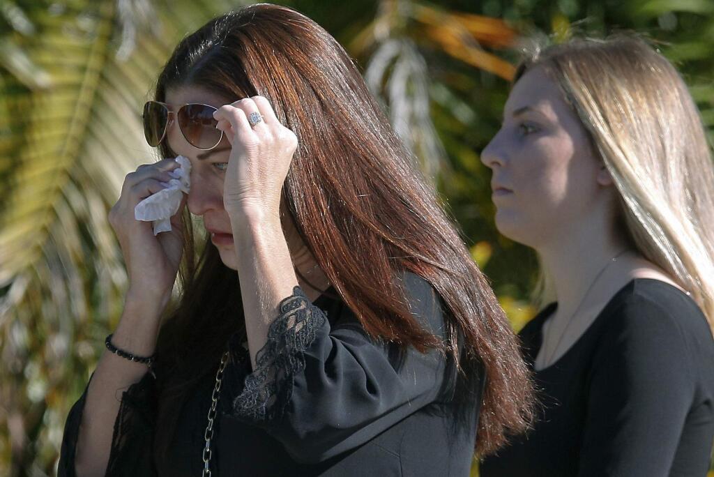 A woman wipes a tear as she arrives before a funeral service for Alyssa Alhadeff at the Star of David Funeral Chapel in North Lauderdale, Fla., Friday, Feb. 16, 2018. Alhadeff was one of the victims of Wednesday shooting at Marjory Stoneman Douglas High School. Nikolas Cruz, a former student, was charged with 17 counts of premeditated murder. (AP Photo/Brynn Anderson)