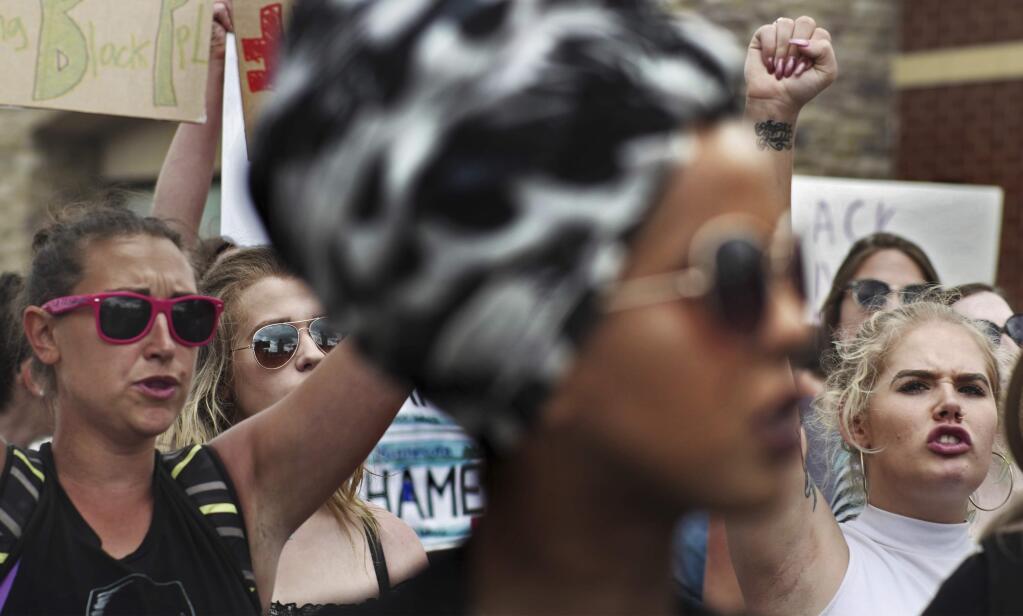 Protesters gather a demonstration, Sunday, June 18, 2017, in St. Anthony, Minn. The protesters marched against the acquittal of Officer Jeronimo Yanez, was found not guilty of manslaughter for shooting Philando Castile during a traffic stop. (Richard Tsong-Taatarii/Star Tribune via AP)