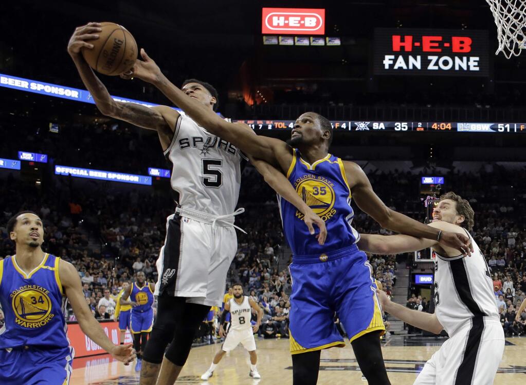 San Antonio Spurs guard Dejounte Murray (5) grabs a rebound in front of Golden State Warriors' Kevin Durant (35) as Shaun Livingston (34) and center Pau Gasol, right, of Spain watch during the first half in Game 4 of the NBA basketball Western Conference finals, Monday, May 22, 2017, in San Antonio. (AP Photo/Eric Gay)