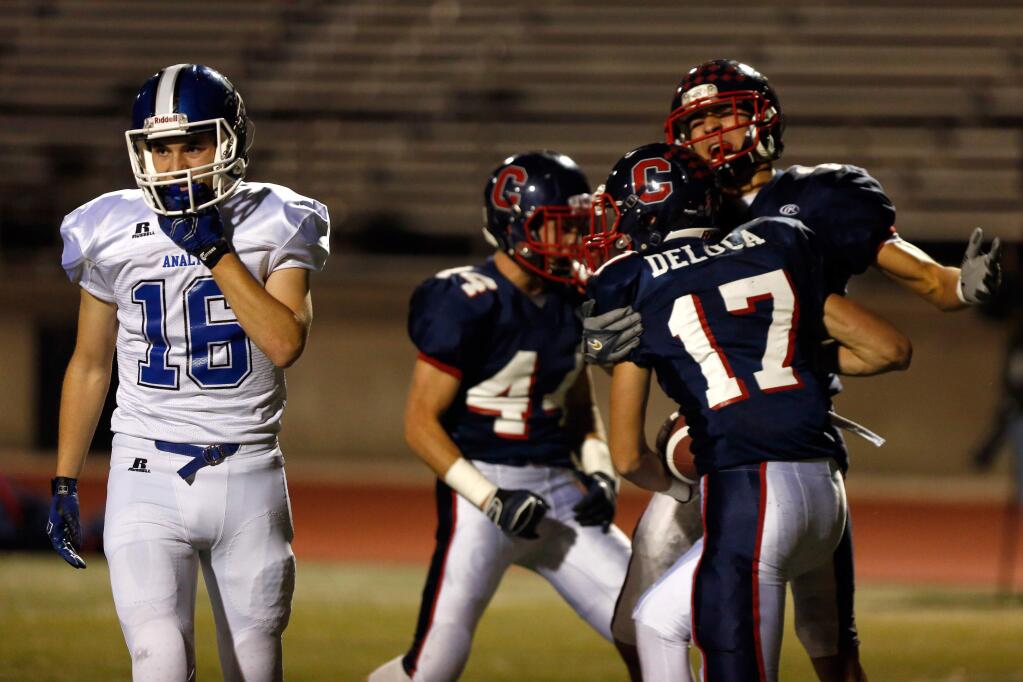 Analy's Spencer Vogel (16) walks off the field while Campolindo's Dante DeLuca (17) celebrates his touchdown during the first half of the NCS Division 3 championship football game between Analy and Campolindo high schools in Pleasant Hill on Friday, Dec. 4, 2015. (Alvin Jornada / The Press Democrat)