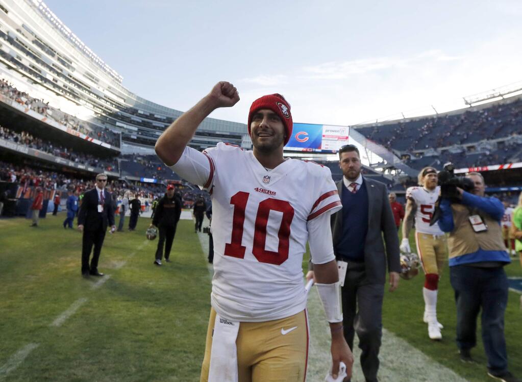 San Francisco 49ers quarterback Jimmy Garoppolo (10) celebrates after an NFL football game against the Chicago Bears, Sunday, Dec. 3, 2017, in Chicago. The 49ers won 15-14. (AP Photo/Charles Rex Arbogast)
