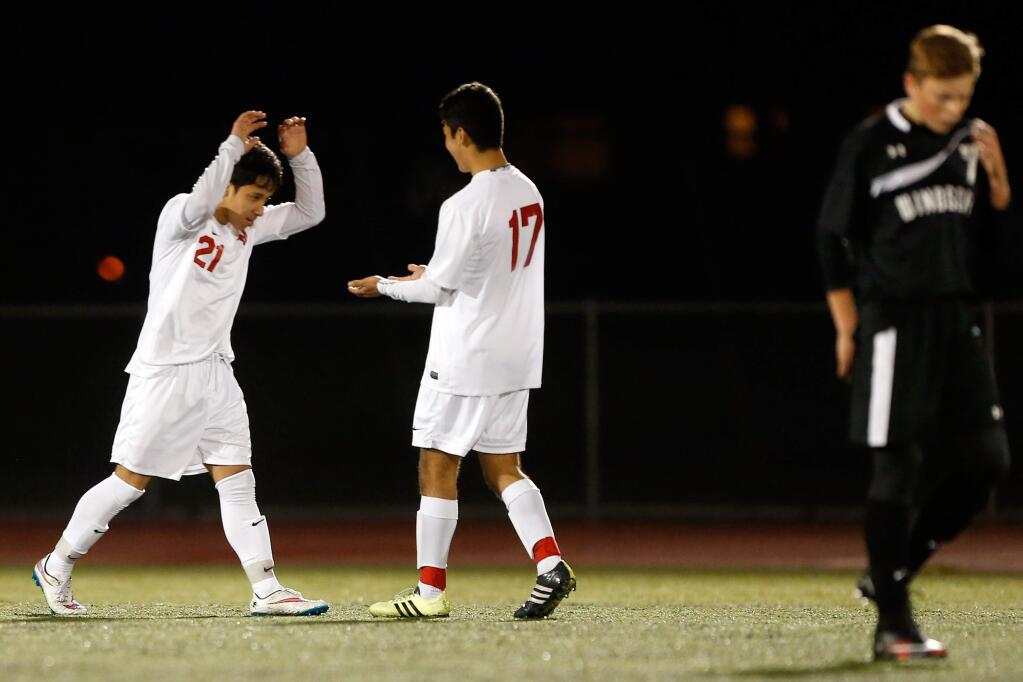 Montgomery's Bryan Rosales (21), left, and Daniel Guerrero (17) celebrate Rosales' second half goal during a boys varsity soccer match between Windsor and Montgomery high schools in Santa Rosa, California, on Wednesday, February 3, 2016. (Alvin Jornada / The Press Democrat)