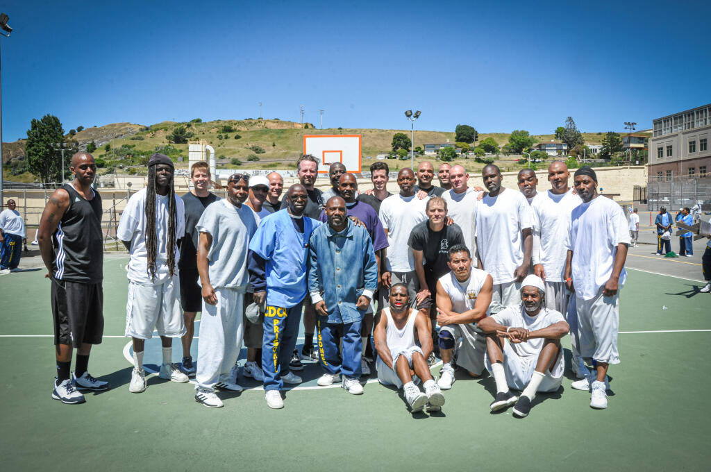 Mark Stapp, back row, third from left, and his visiting team together with members of the San Quentin Kings basketball squad, on April 30, 2016. (Courtesy of San Quentin News, Eddie Herena)