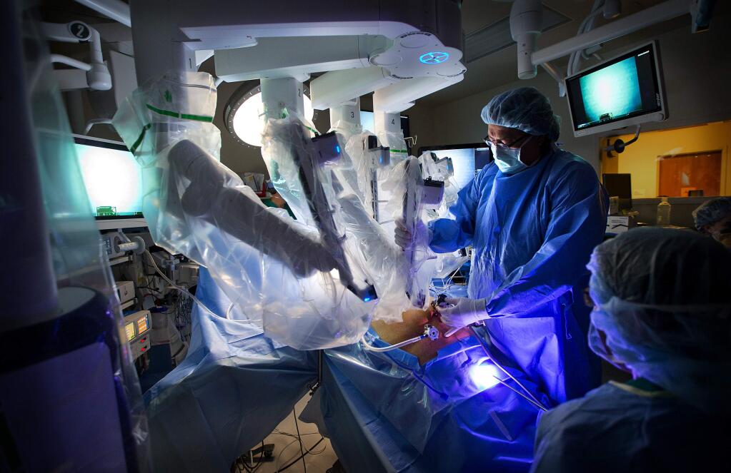 Dr. Allen Cortez prepares for a laproscopic sleeve gastrectomy using the $2 million da Vinci Robotic Surgery system at Sutter Hospital in Santa Rosa. (JOHN BURGESS / The Press Democrat)