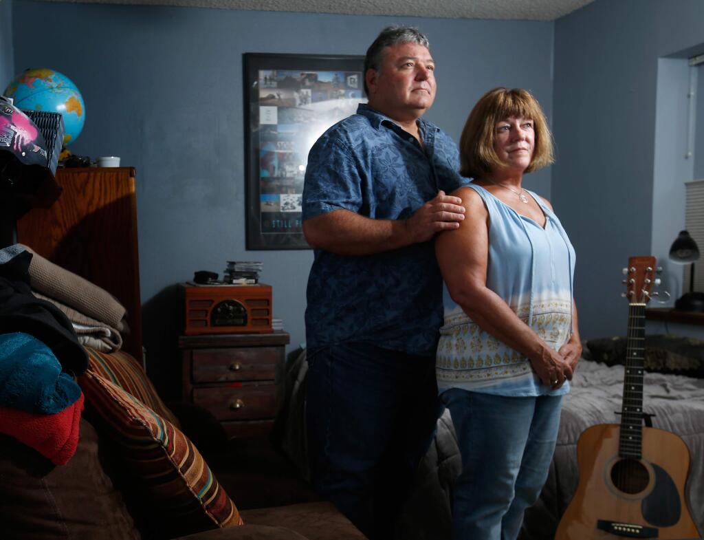 Eric and Connie Petereit pose for a portrait in their son's bedroom, at their home in Healdsburg, California on Thursday, August 24, 2017. Eric and Connie's son was diagnosed with schizophrenia in 2013, when he was 19 years old. (Alvin Jornada / The Press Democrat)